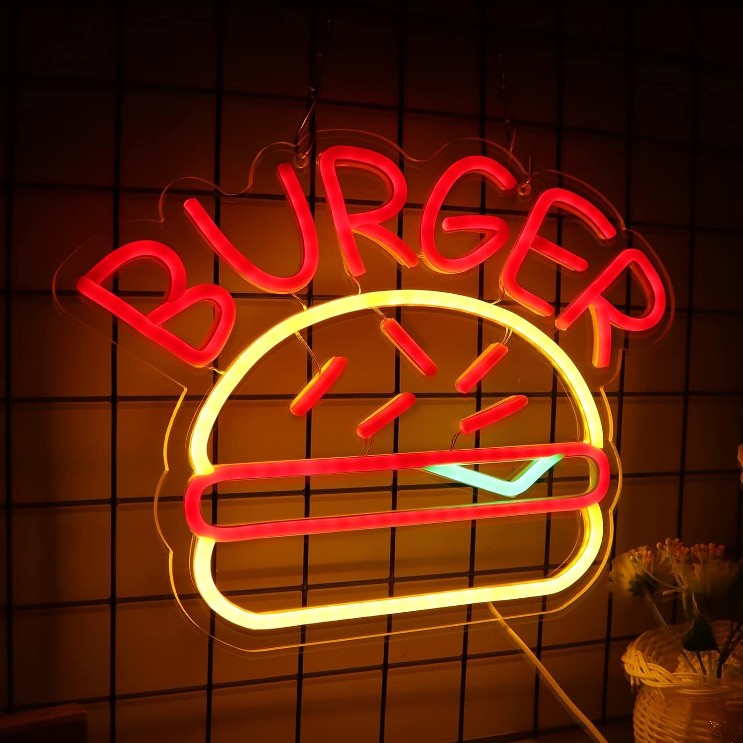 Logotipo de letrero de neón con iluminación de hamburguesas en la pared